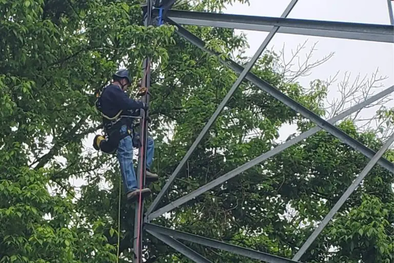 Worker climbing metal structure
