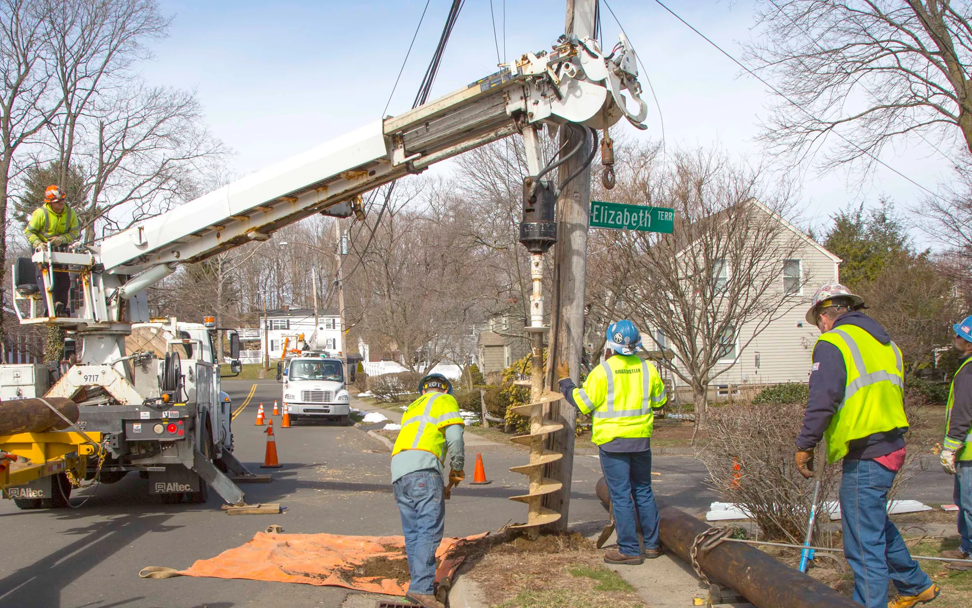 Workers drilling a hole into the ground