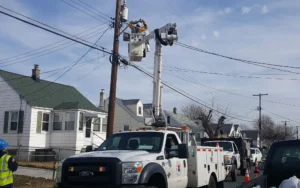 Bucket truck with workers working on outdoor lighting poles