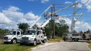 Workers using bucket trucks for work on powerlines