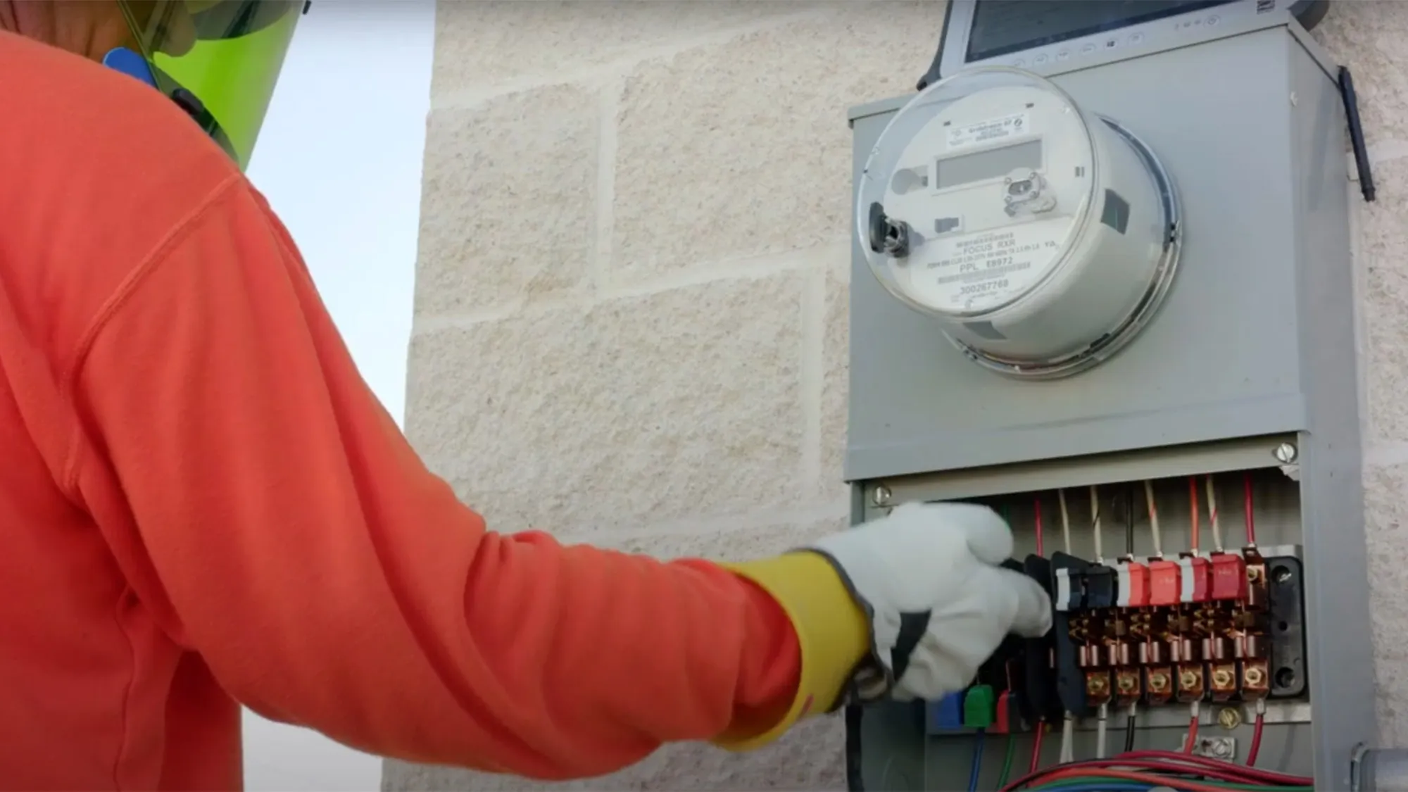 Worker installing electrical meter