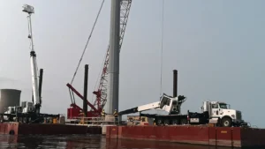 Bucket trucks on a platform in water